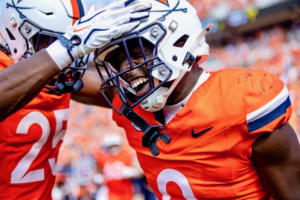 <p>Xavier Brown celebrates with his teammates after punching in his first of two touchdowns in his return from an ACL tear.</p>