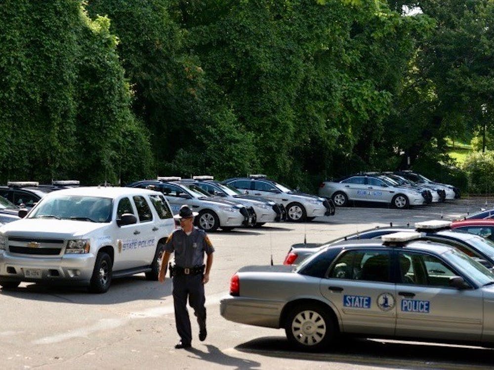 State trooper vehicles stationed in the parking lot beside the Lambeth Field residence area, where many personnel are being housed.