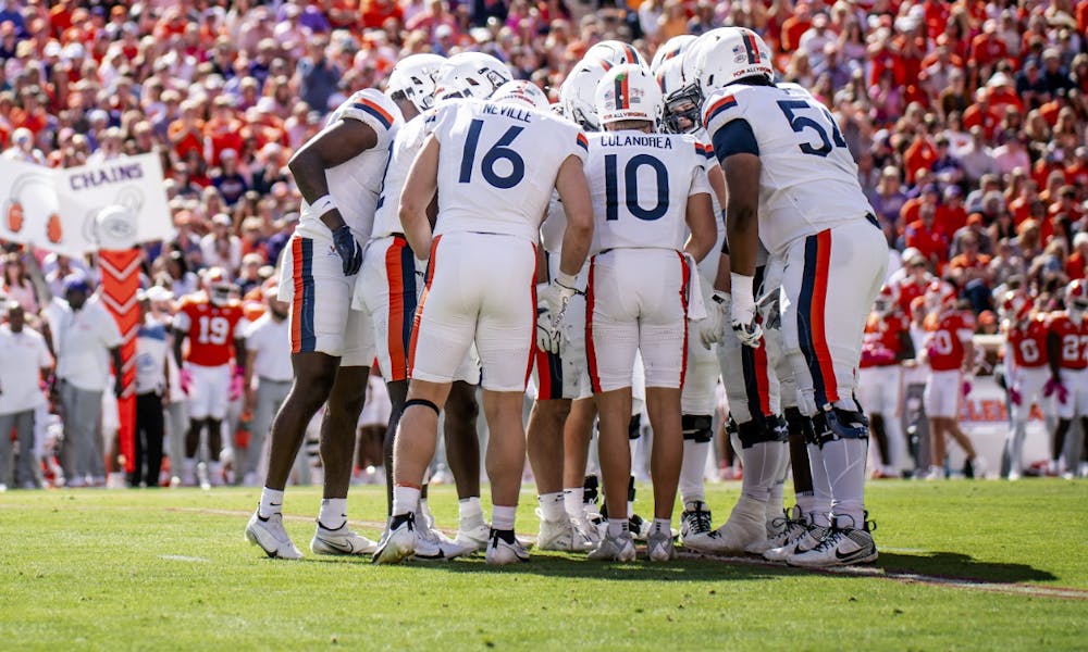 The Cavalier offenses huddles before a critical third down at Clemson.