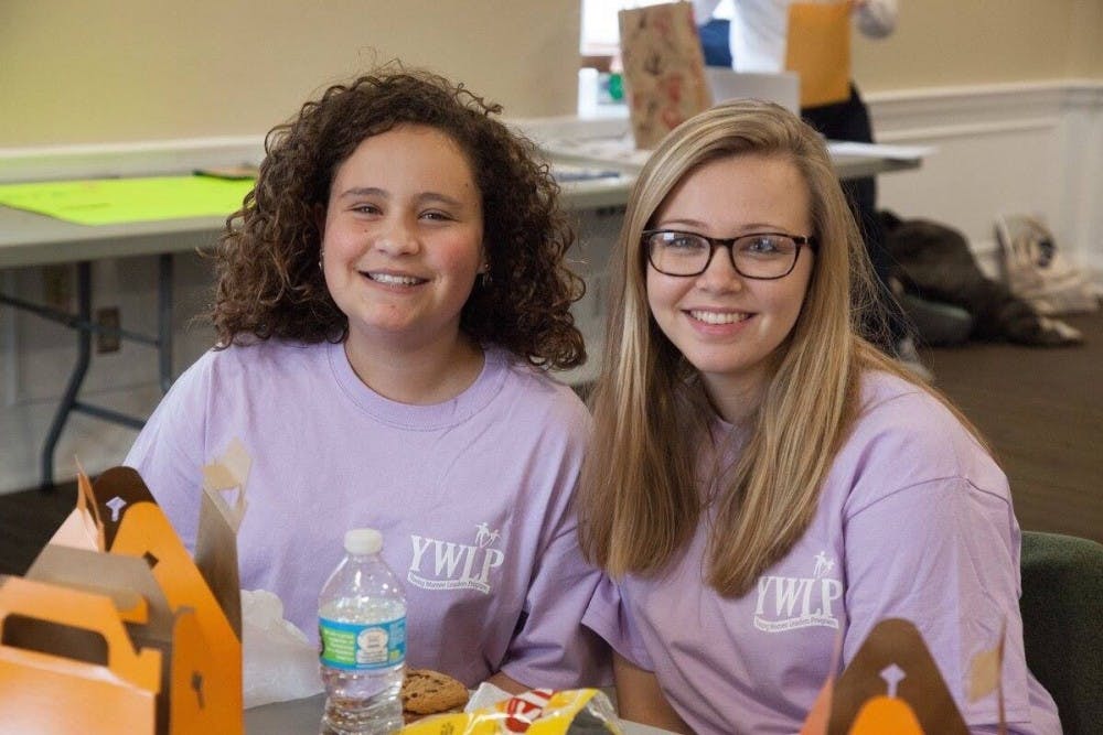 Second-year Curry student Nicole Baker (right) poses with her Young Women Leaders Program little sister.