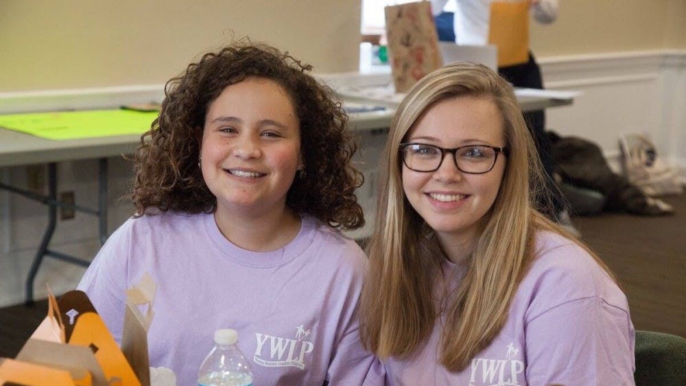 Second-year Curry student Nicole Baker (right) poses with her Young Women Leaders Program little sister.
