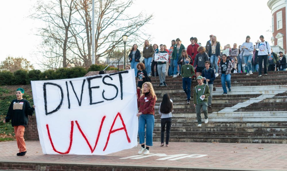 <p>DivestUVA leaders and rally attendees marched from the steps of the Rotunda to Madison Hall, where a list of demands centering around fossil fuel divestment was affixed to the main entrance.</p>
