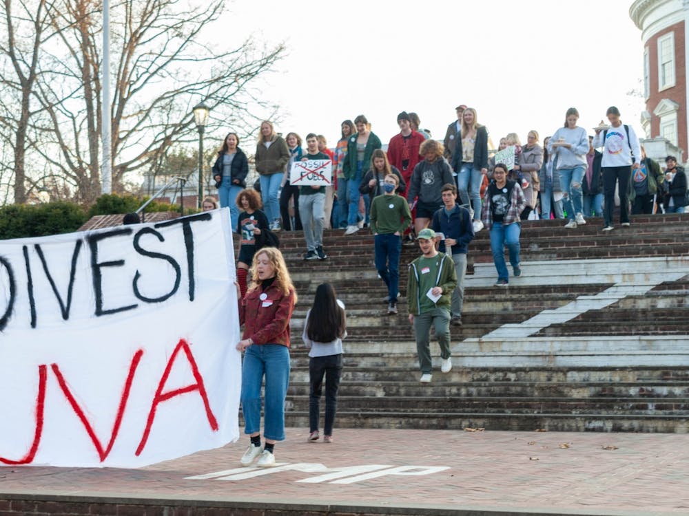 DivestUVA leaders and rally attendees marched from the steps of the Rotunda to Madison Hall, where a list of demands centering around fossil fuel divestment was affixed to the main entrance.