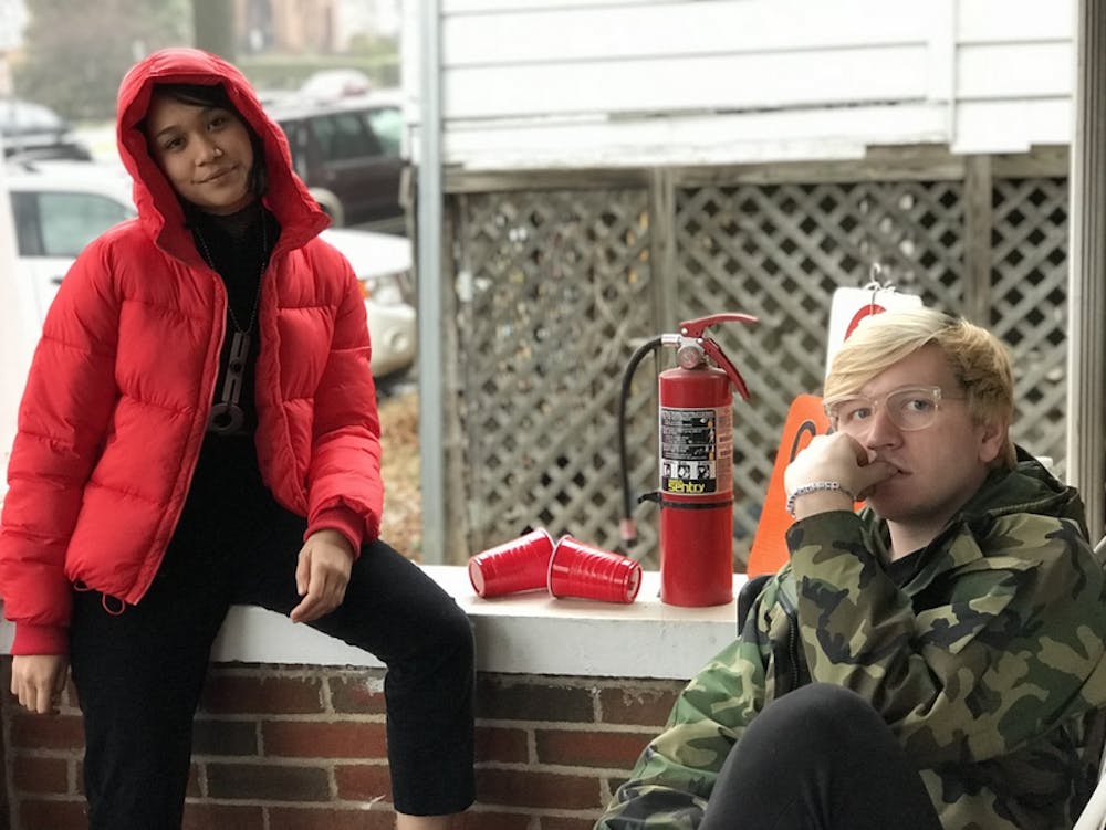 <p>Fourth-year College student Lona Manik wears a red puffer coat from American Eagle Outfitters and third-year College student Ian Ware wears a taupe faux-fur coat from Urban Outfitters.</p>