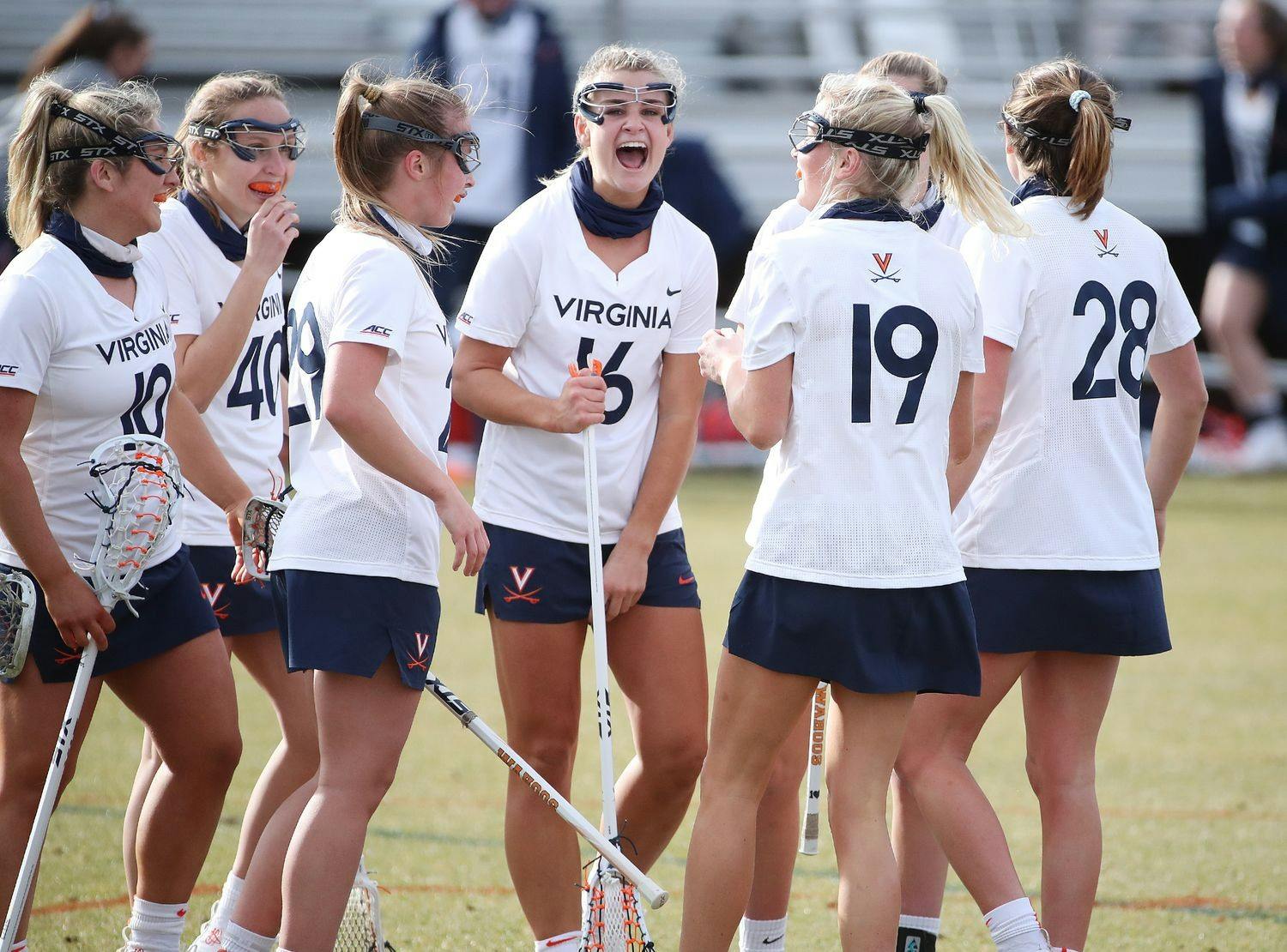 The Virginia women's lacrosse team celebrates following a goal against rival Virginia Tech.