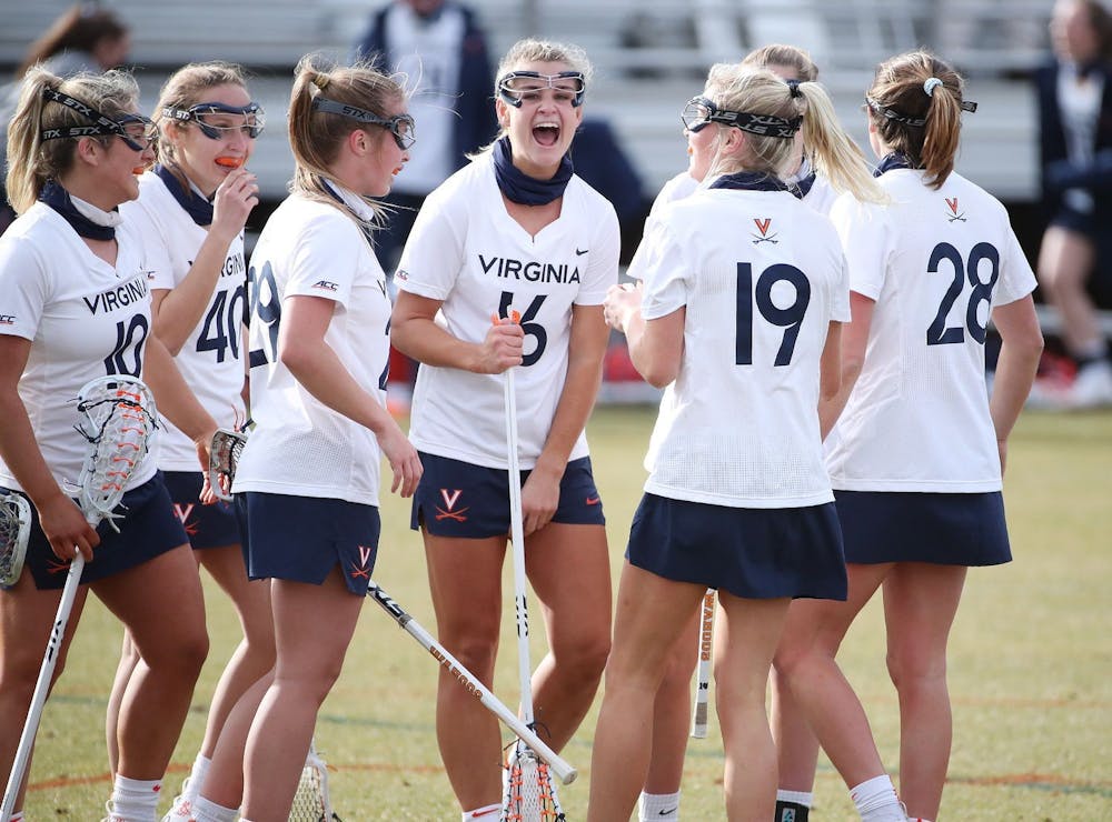 <p>The Virginia women's lacrosse team celebrates following a goal against rival Virginia Tech.</p>