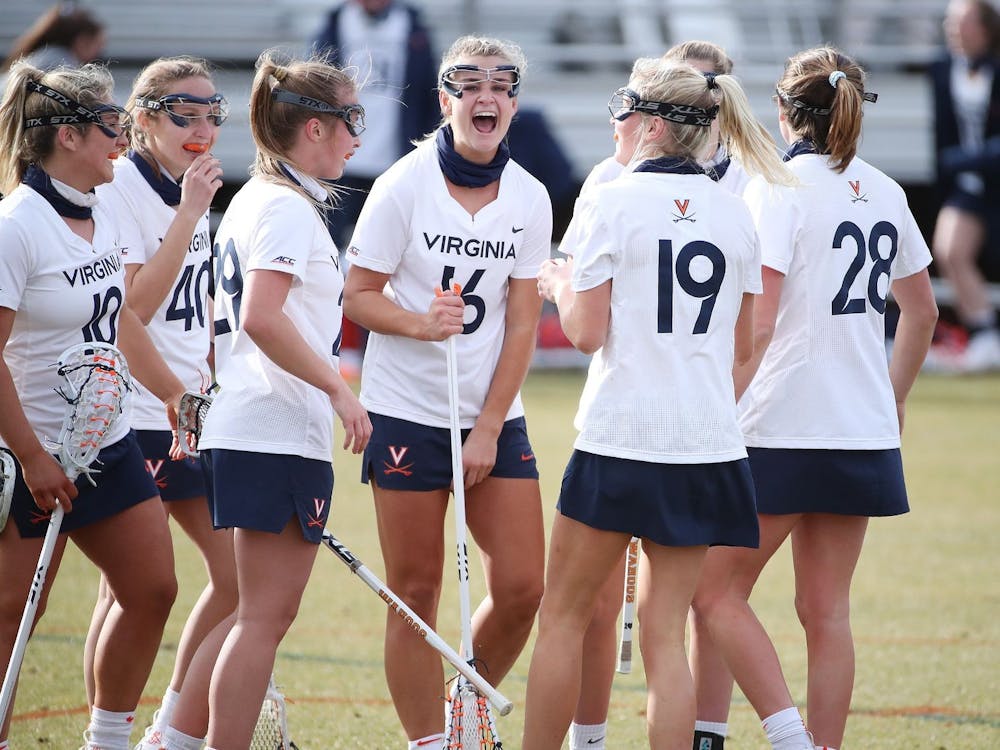 The Virginia women's lacrosse team celebrates following a goal against rival Virginia Tech.