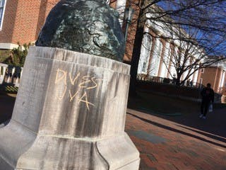 Messages including “DIVEST UVA,” “PEOPLE + PLANET over PROFIT,” “UVA PROFITS OFF DESTRUCTION OF OUR ENVIRONMENT,” “F—k UVA SAVE THE PLANET” and “DIVEST UVA from fossil fuel companies” were found graffitied in chalk across Central Grounds Dec. 7, following Board of Visitors meetings. (Kate Bellows, Patrick Roney // CD Photo)