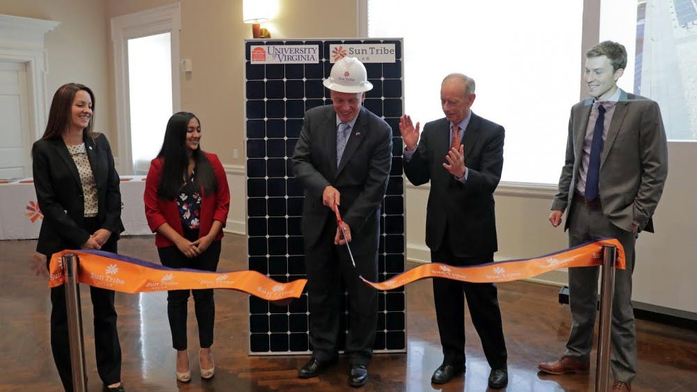 From left, Deputy Secretary of Natural Resources for the Governors Office Angela Navarro, U.Va. student Suchita Chharia, Governor Terry McAuliffe,  U.Va. Executive Vice President and COO Pat Hogan and Sun Tribe Solar co-foiunder Taylor Brown were part of a ribbon cutting ceremony for new 126KW-AC solar panel array installation on the roof Clemens Library Tuesday at the University of Virginia in Charlottesville, Va. Sun Tribe Solar partnered with U.Va. on the project. The ceremony was part of U.Va.'s Earth Week celebration. Photo/Sun Tribe Solar