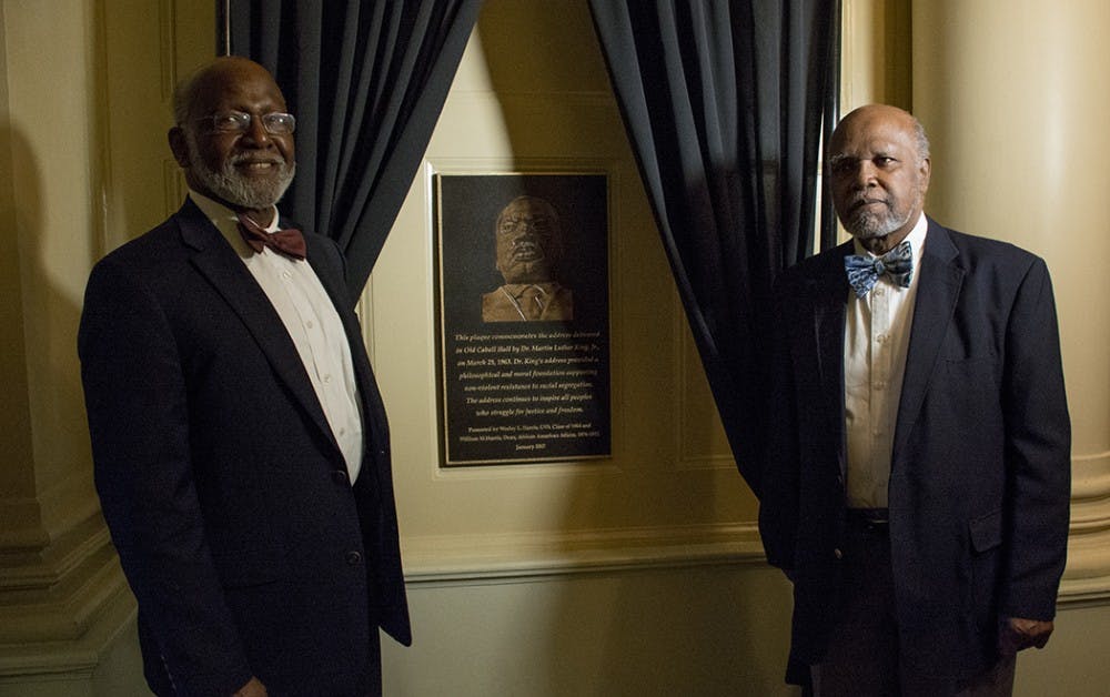 <p>Wesley Harris (left) and William Harris&nbsp;standing next to the plaque they donated in honor of Martin Luther King Jr.'s 1963 visit to the University.&nbsp;</p>