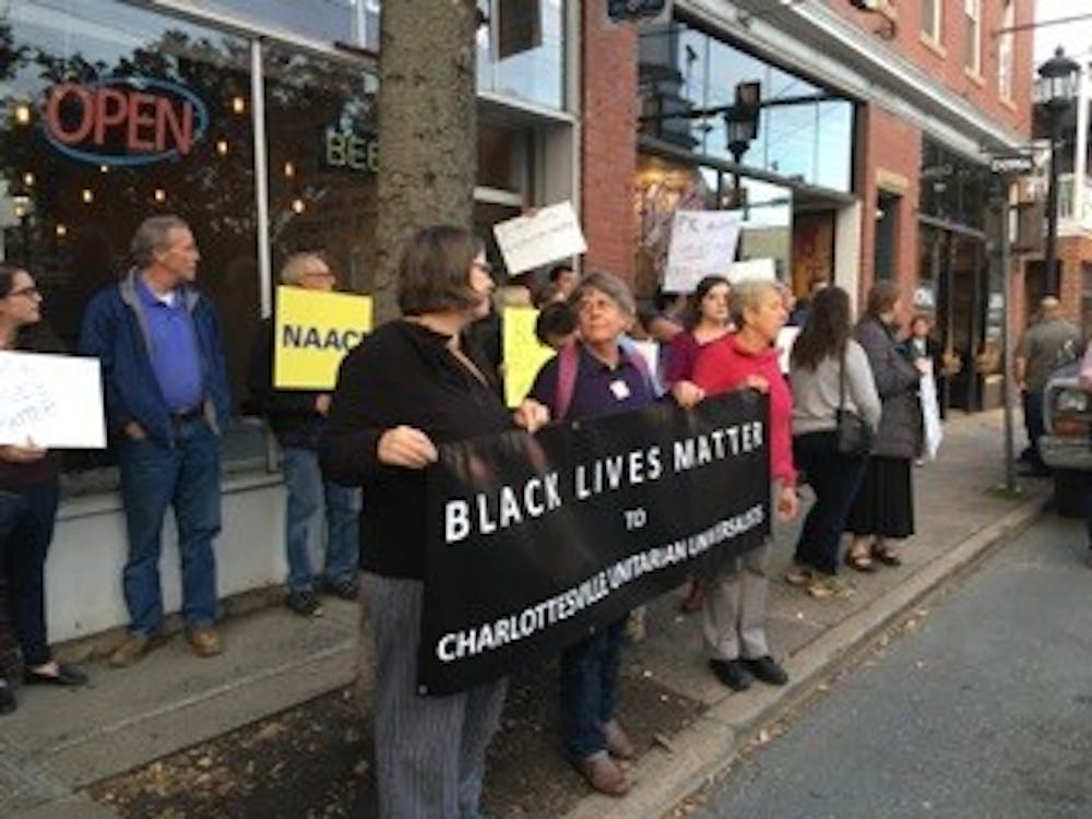 <p>Protesters gather outside Bella's Restaurant.</p>