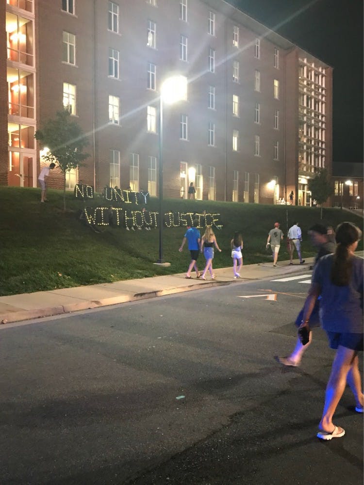 Activists held up the sign following the Concert for Unity Sunday evening.