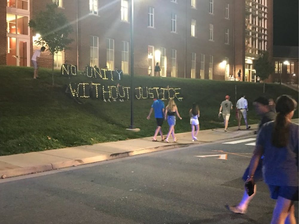 Activists held up the sign following the Concert for Unity Sunday evening.