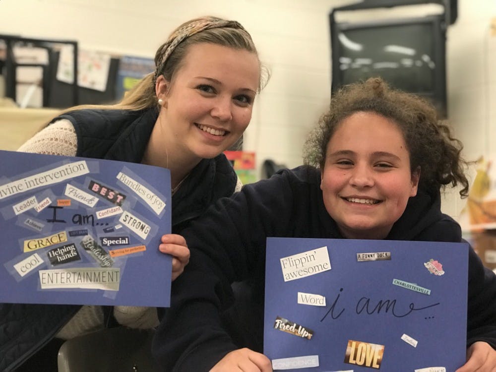 Nicole Baker and her "little sister" after they found words in magazines to describe their personal attributes. 