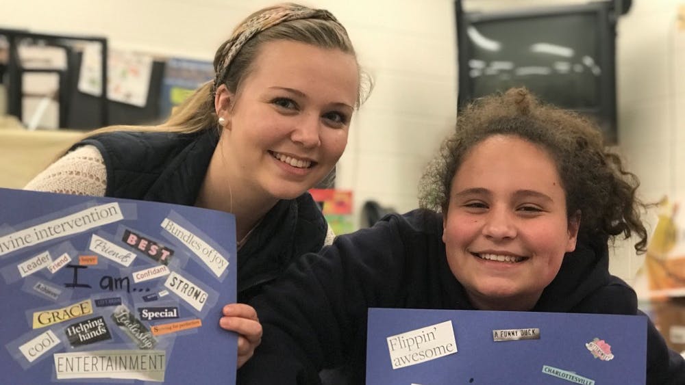 Nicole Baker and her "little sister" after they found words in magazines to describe their personal attributes.