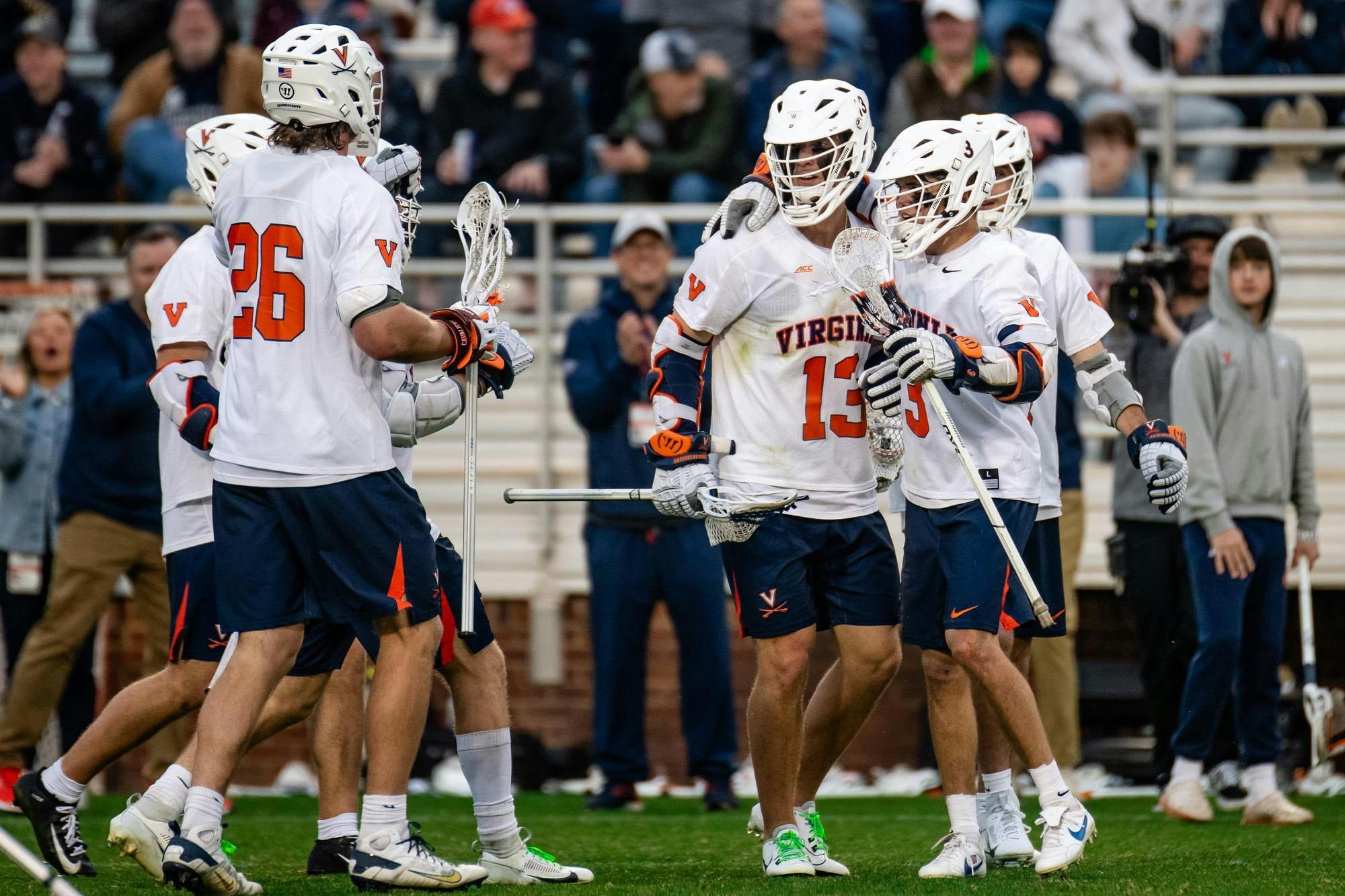 Virginia's offense clusters after a goal March 15 against Maryland.