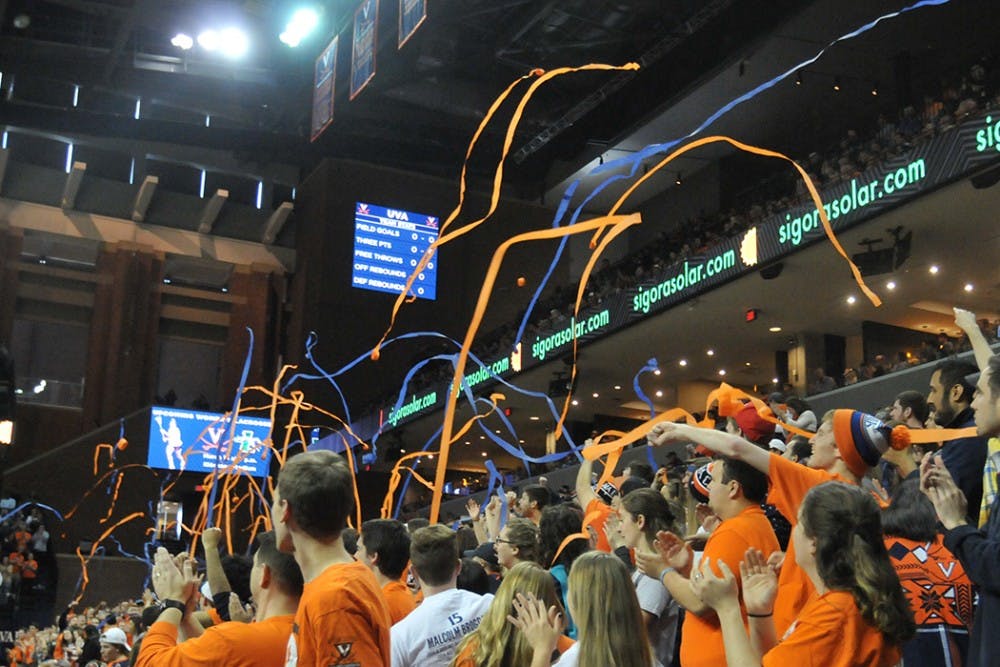 Hoo Crew hands out the streamers students throw during basketball games.