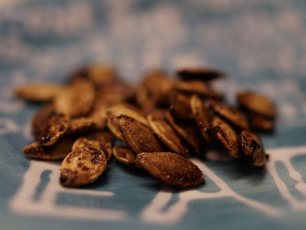 Roasted pumpkin seeds are easy to make, and they can be the perfect snack for second-round midterm cramming. 