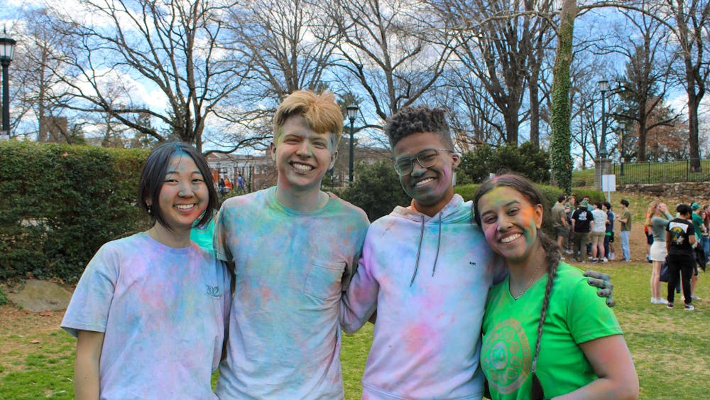 At the end of the celebration, attendees grabbed cups filled with bright powder and engaged in the Holi tradition of playfully throwing color at each other.
