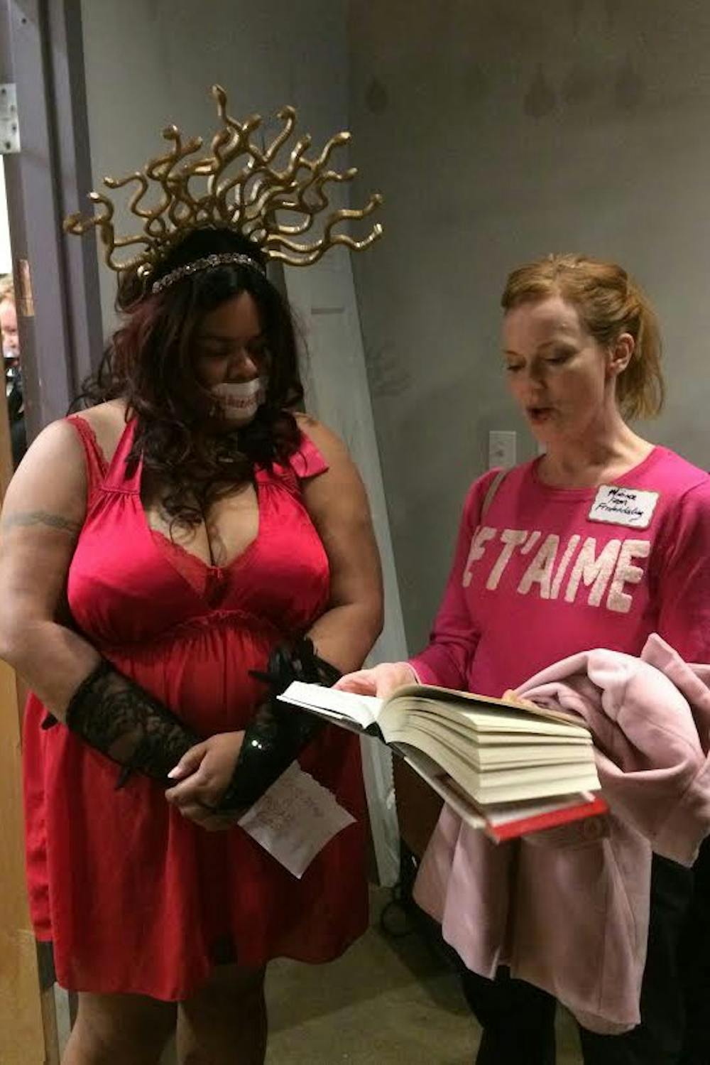 <p>Veronica Haunani Fitzhugh stands with a spectator at the "Nasty Women" exhibition.</p>