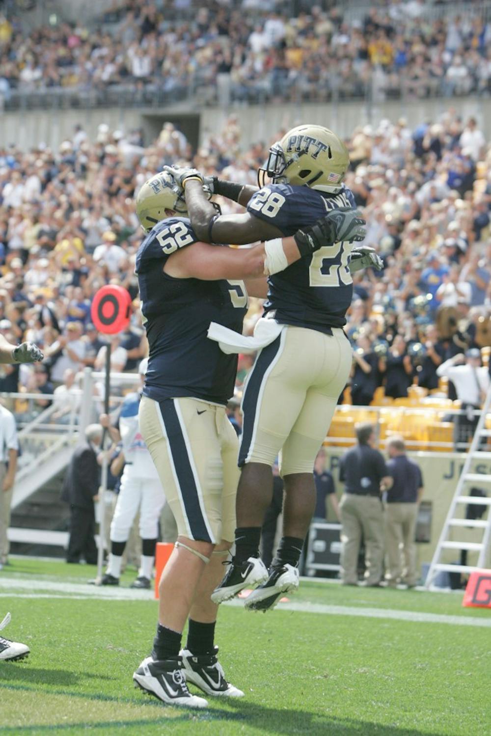 PITTSBURGH - SEPTEMBER 11:  Dion Lewis #28 of Pittsburgh Panthers celebrates his touchdown with teammate Lucas Nix #52 against the New Hampshire Wildcats at Heinz Field on September 11, 2010 in Pittsburgh, Pennsylvania. Pittsburgh defeated New Hampshire 38-16.  (Photo by Charles LeClaire/Getty Images)