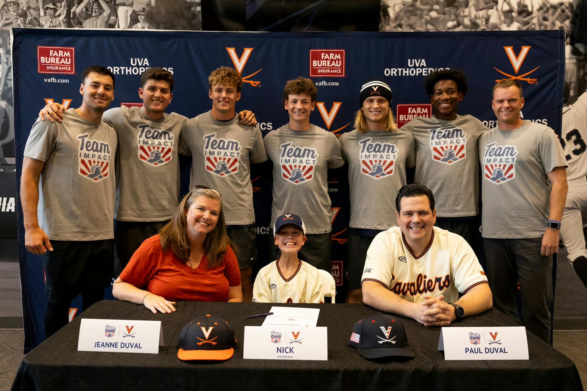 Duval poses for a photo with his parents and members of the Virginia baseball program.