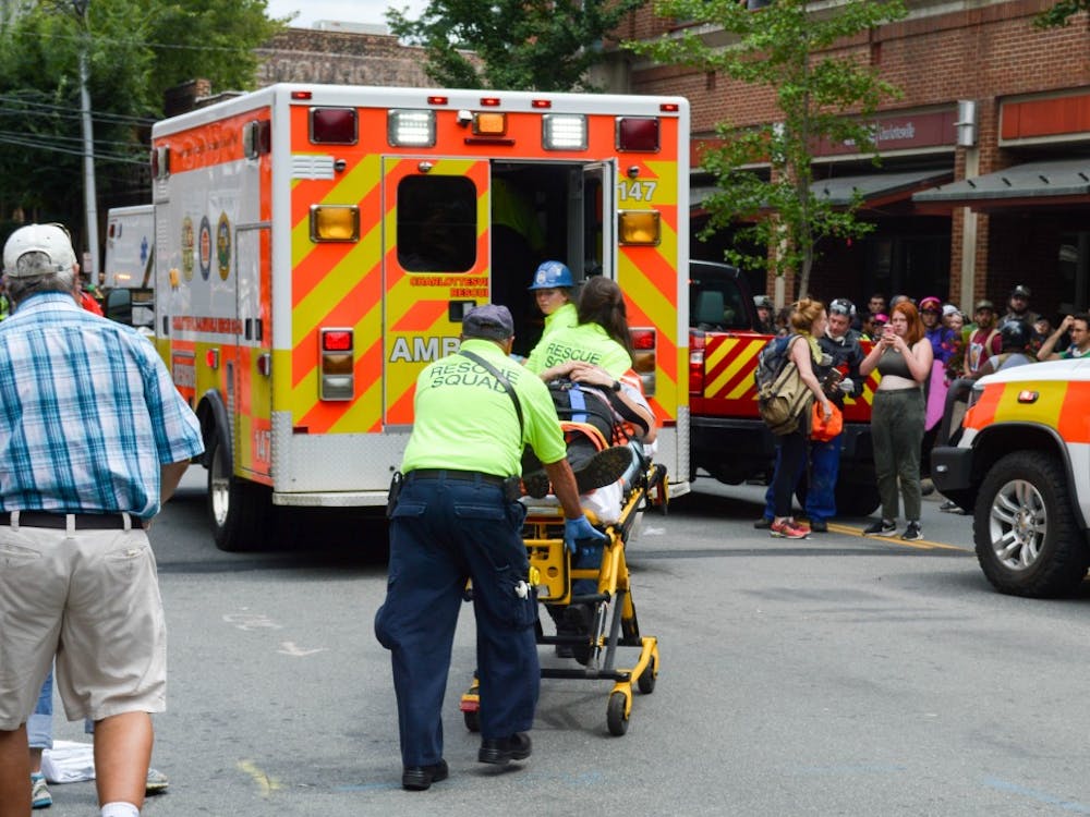 Medical personnel helping someone who was injured when a car plowed through a crowd of people near the Downtown Mall. 
