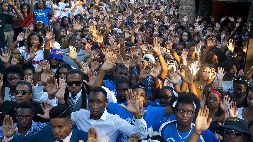 individuals pose for a "Hands Up, Don't Shoot" photo in August as part of a national movement in solidarity with Michael Brown.