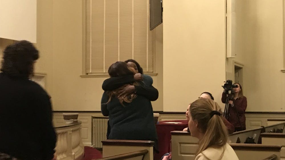 Survivors Lisa, who declined to give her last name, and Tay Washington embrace each other after sharing their stories with attendees at the First United Methodist Church Friday.&nbsp;