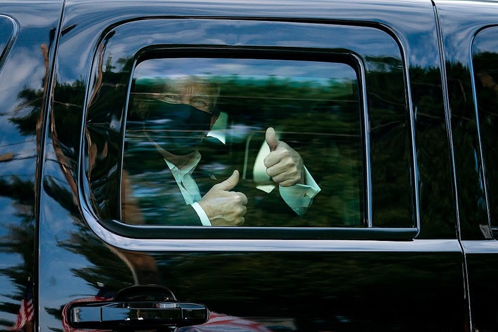 <p>President Donald J. Trump greets supporters during a drive by outside of Walter Reed National Military Medical Center Sunday, Oct. 4, 2020, in Bethesda, Md.</p>