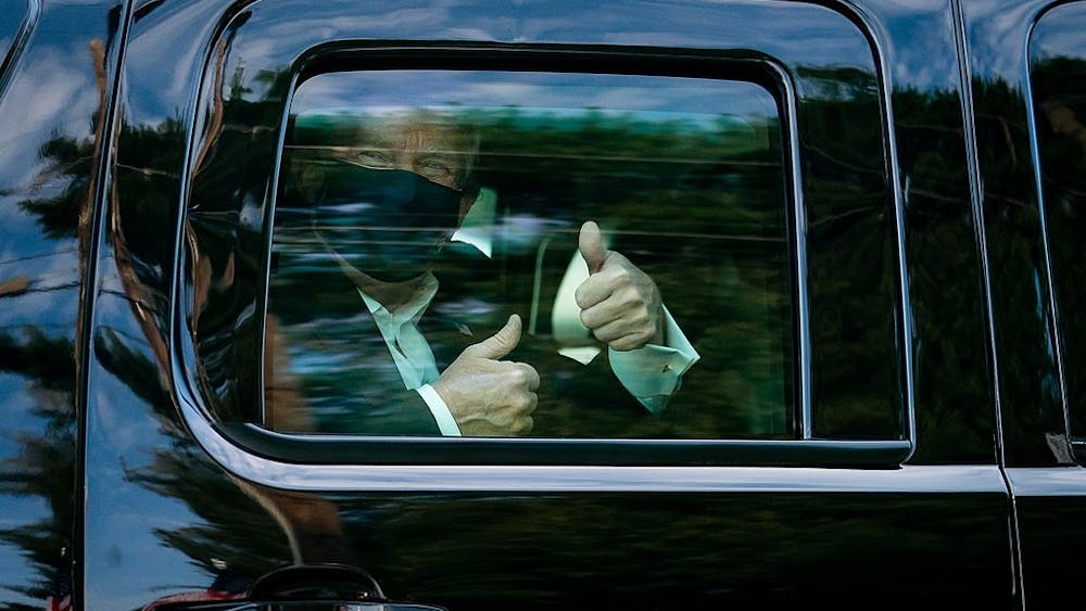 President Donald J. Trump greets supporters during a drive by outside of Walter Reed National Military Medical Center Sunday, Oct. 4, 2020, in Bethesda, Md.