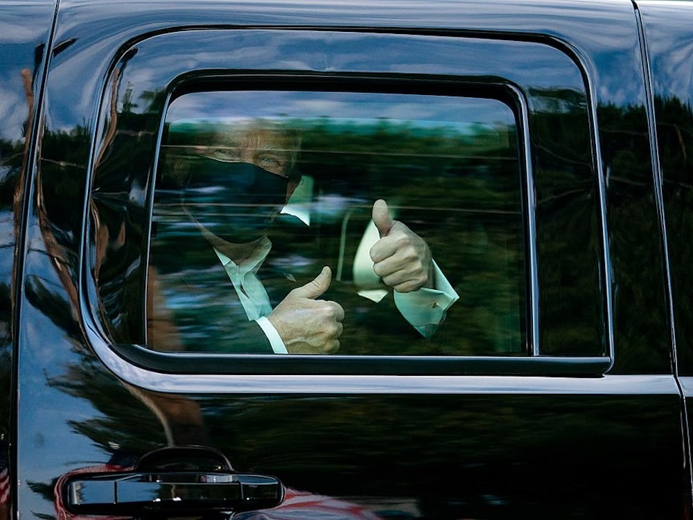 President Donald J. Trump greets supporters during a drive by outside of Walter Reed National Military Medical Center Sunday, Oct. 4, 2020, in Bethesda, Md.
