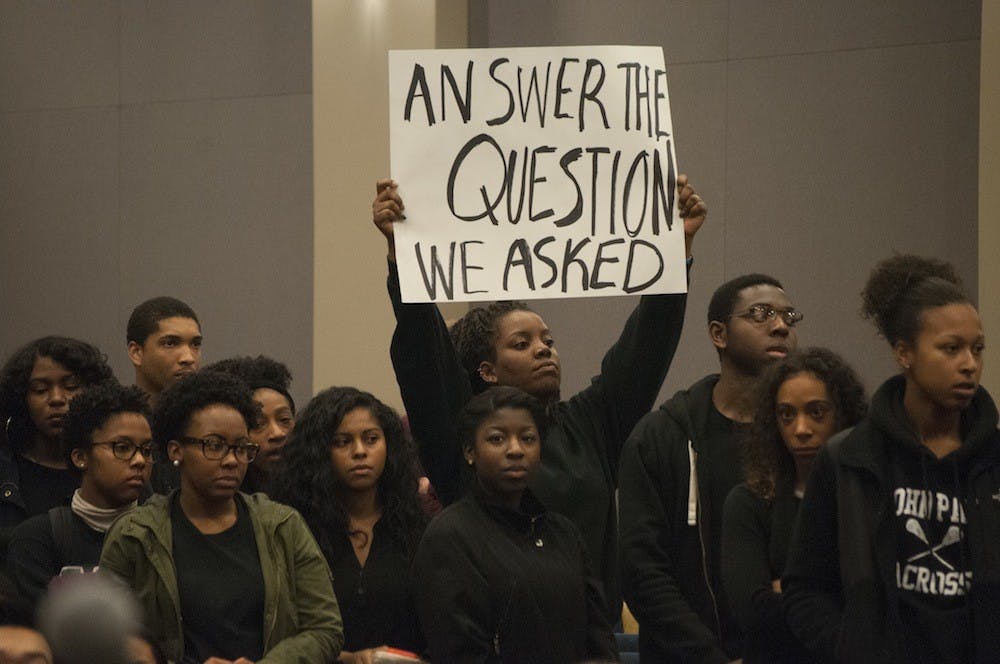 Throughout the panel session attendees shouted, "answer the question we asked."