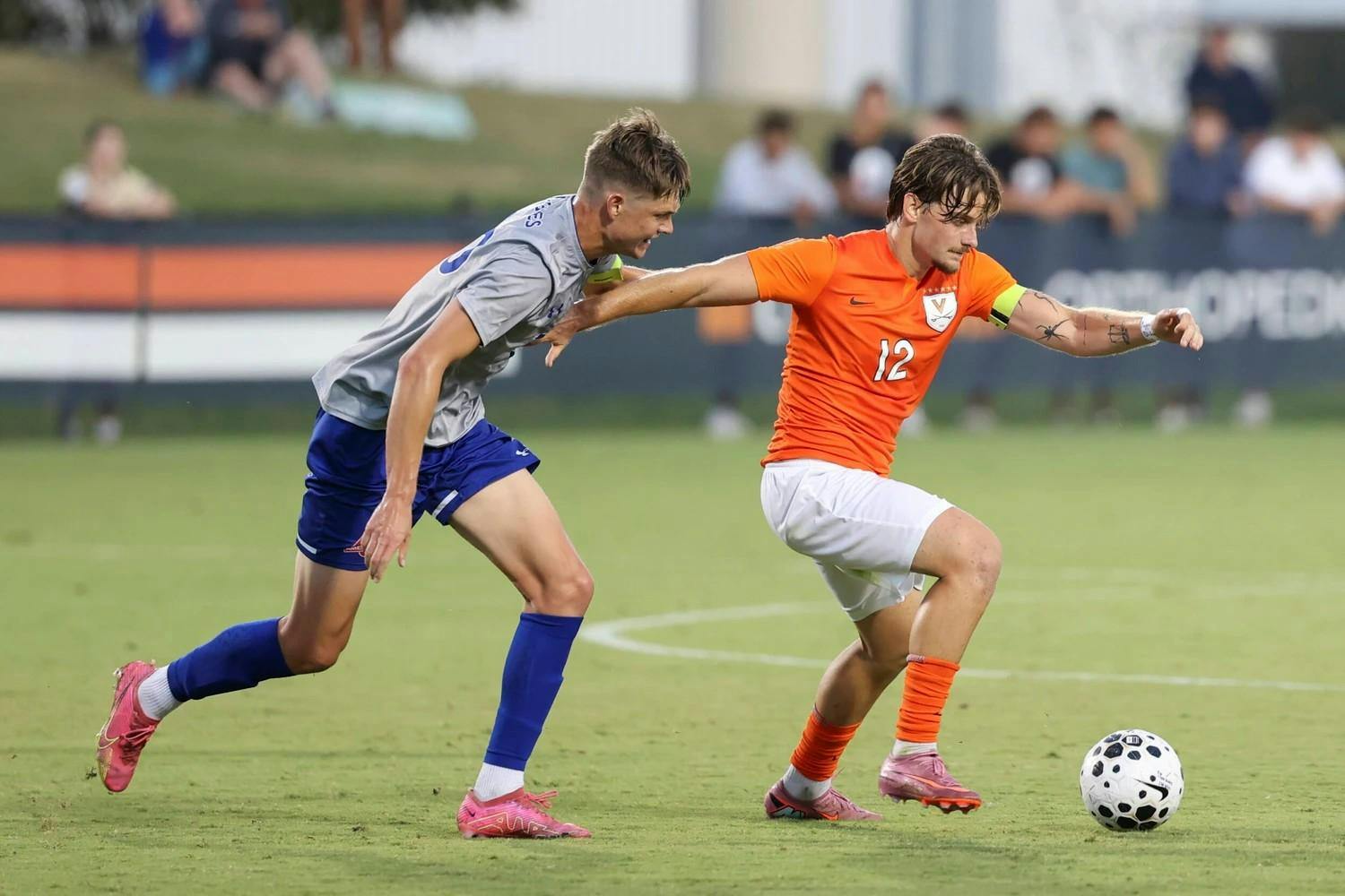 Albin Gashi operates near midfield, an American defender hounding him.