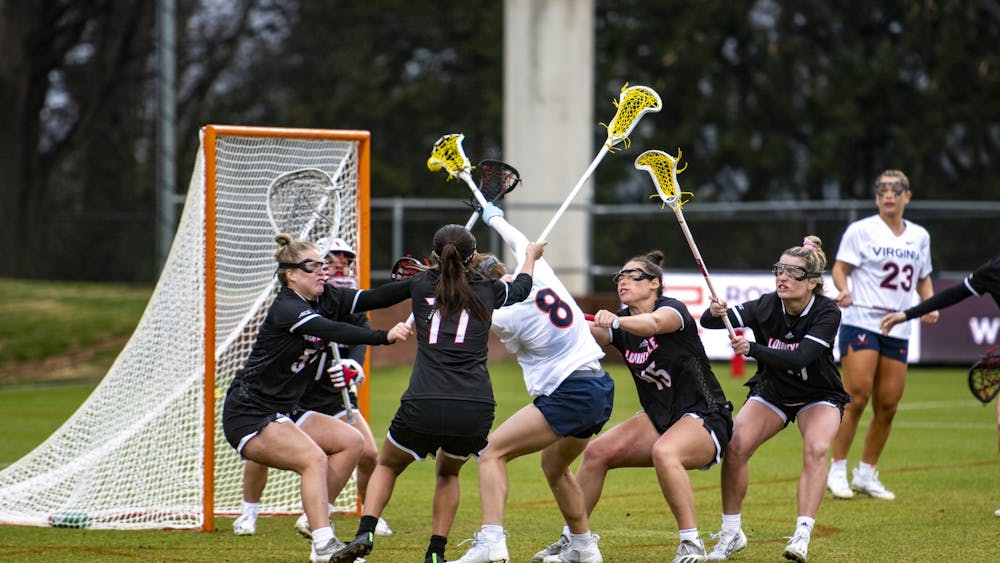 Senior midfielder Jamie Biskup fights through a crowded Louisville defense to attempt to score.