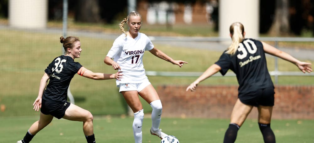 <p>Junior defender Tatum Galvin looks to attack a pair of Wake Forest defenders.</p>