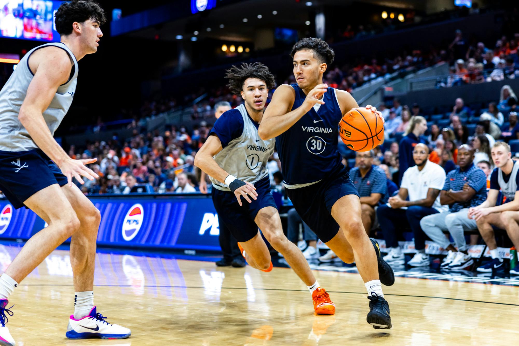 Christian Bliss drives past Jalen Warley.