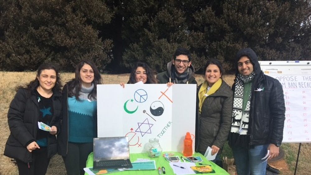 Students from the Persian Cultural Society and Iranian Student Association tabling to raise awareness for green card, visa holders impacted by Trump's latest immigration order.