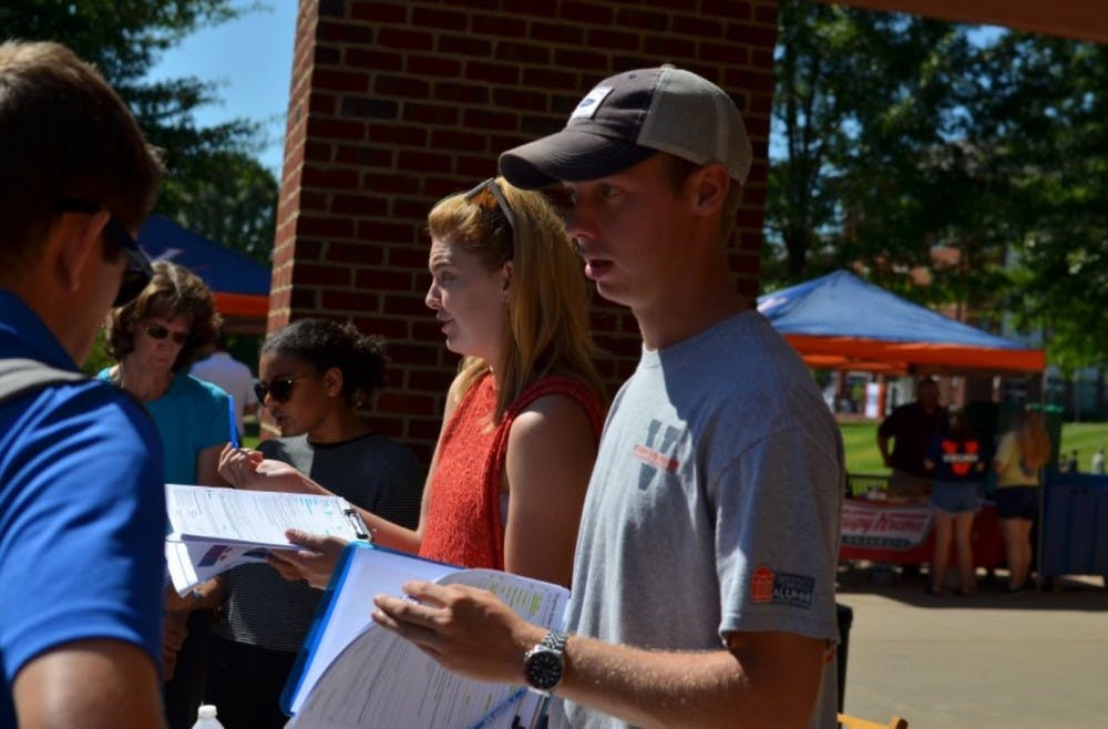 <p>Student Council Legislative Affairs Chair Isaac Weintz (right) and University Democrats President Mary Alice Kukoski (center) facilitate volunteers outside Observatory Hill Dining Hall last month while registering first-year students to vote. &nbsp;</p>