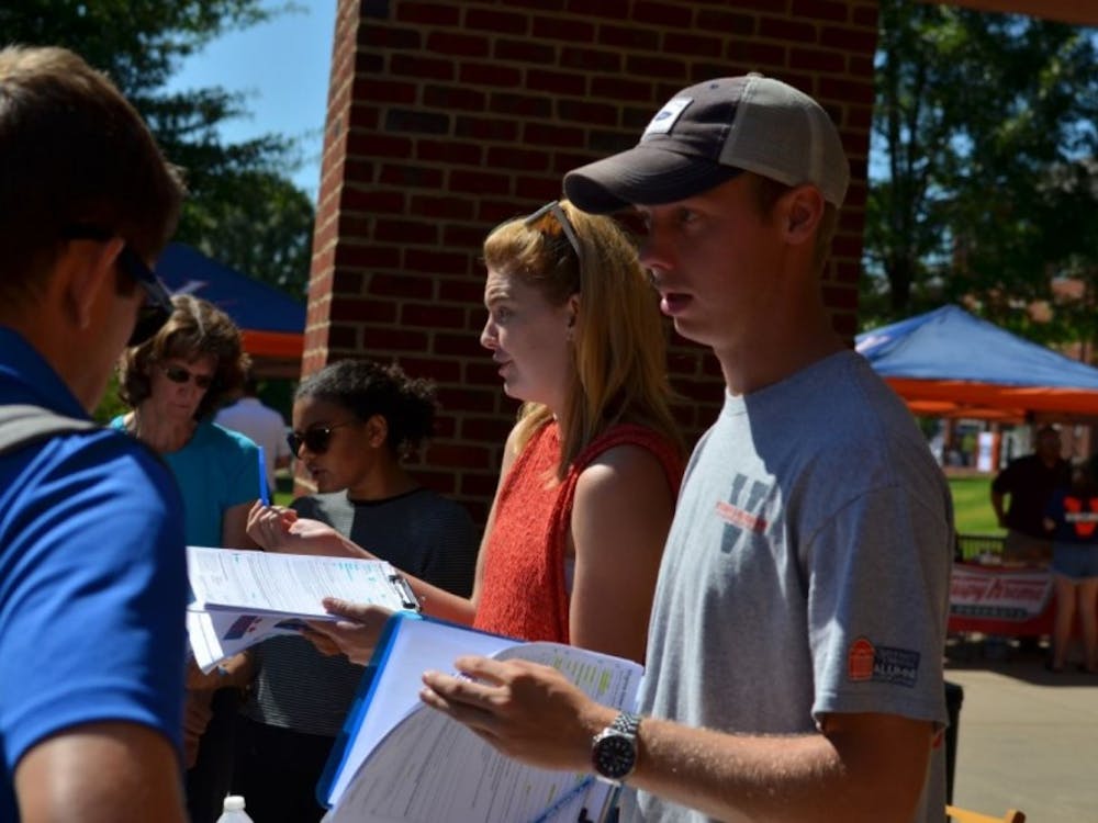 Student Council Legislative Affairs Chair Isaac Weintz (right) and University Democrats President Mary Alice Kukoski (center) facilitate volunteers outside Observatory Hill Dining Hall last month while registering first-year students to vote. &nbsp;