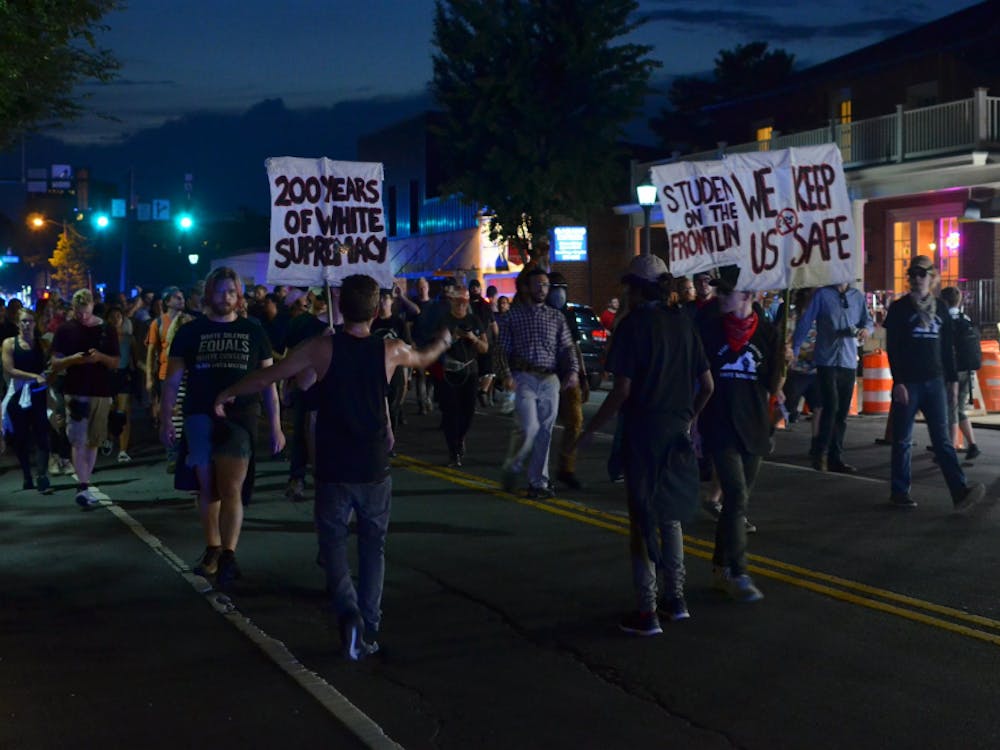 Demonstrators move towards the Downtown Mall during the march on Saturday night.