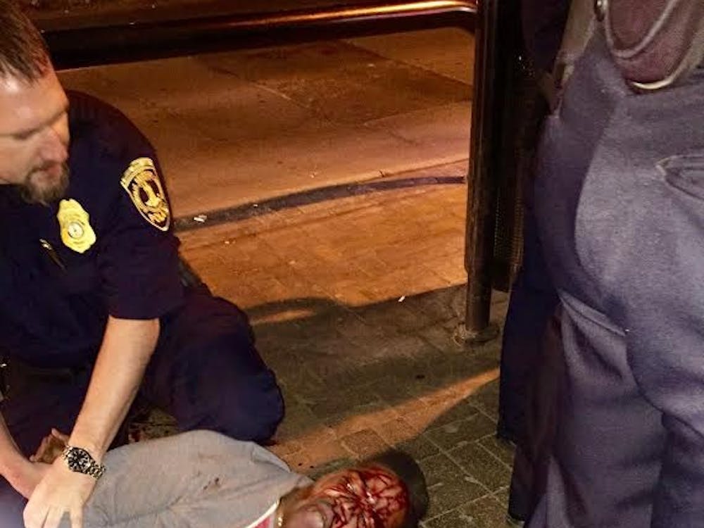 Black Dot, in an email circulated to University students and administrators, attached a photo of Johnson being held outside Trinity Irish Pub on the Corner.