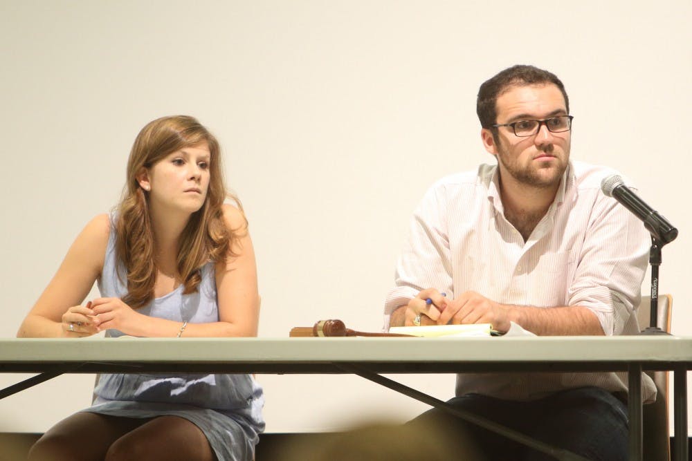 <p>Student Council President Sarah Kenny and Chair of the Representative Body David Birkenthal listening to speakers at the town hall.&nbsp;</p>