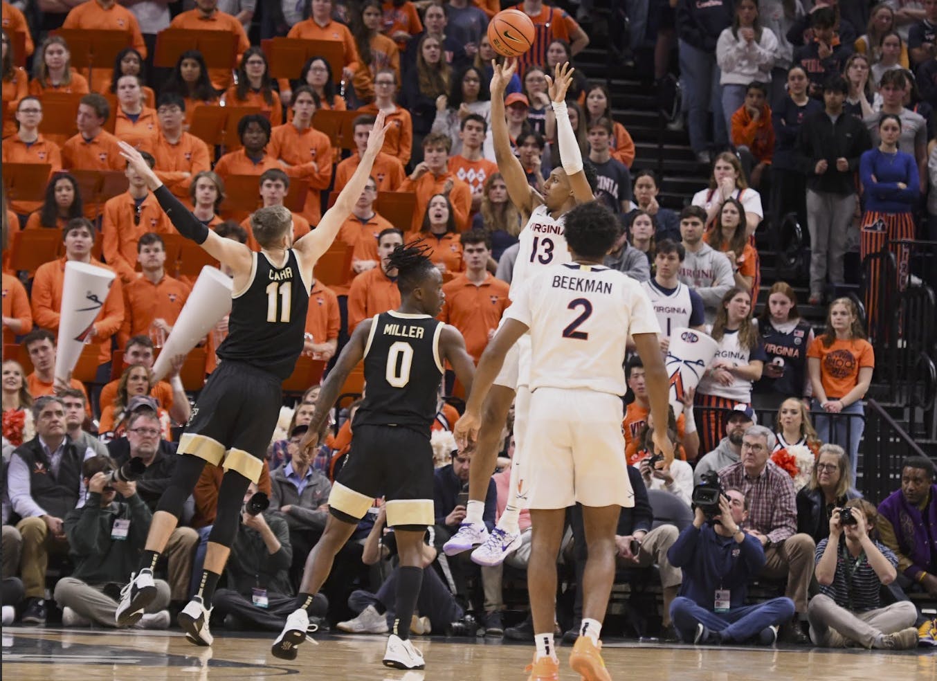 Dunn fires a jump shot as Beekman looks on.