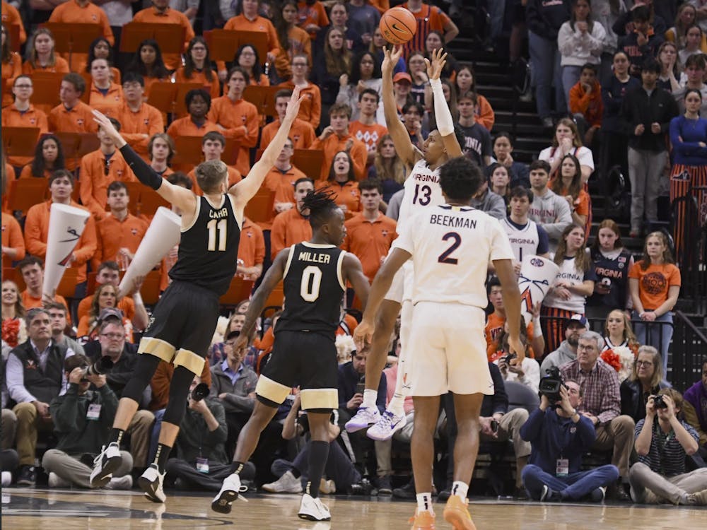 Dunn fires a jump shot as Beekman looks on.