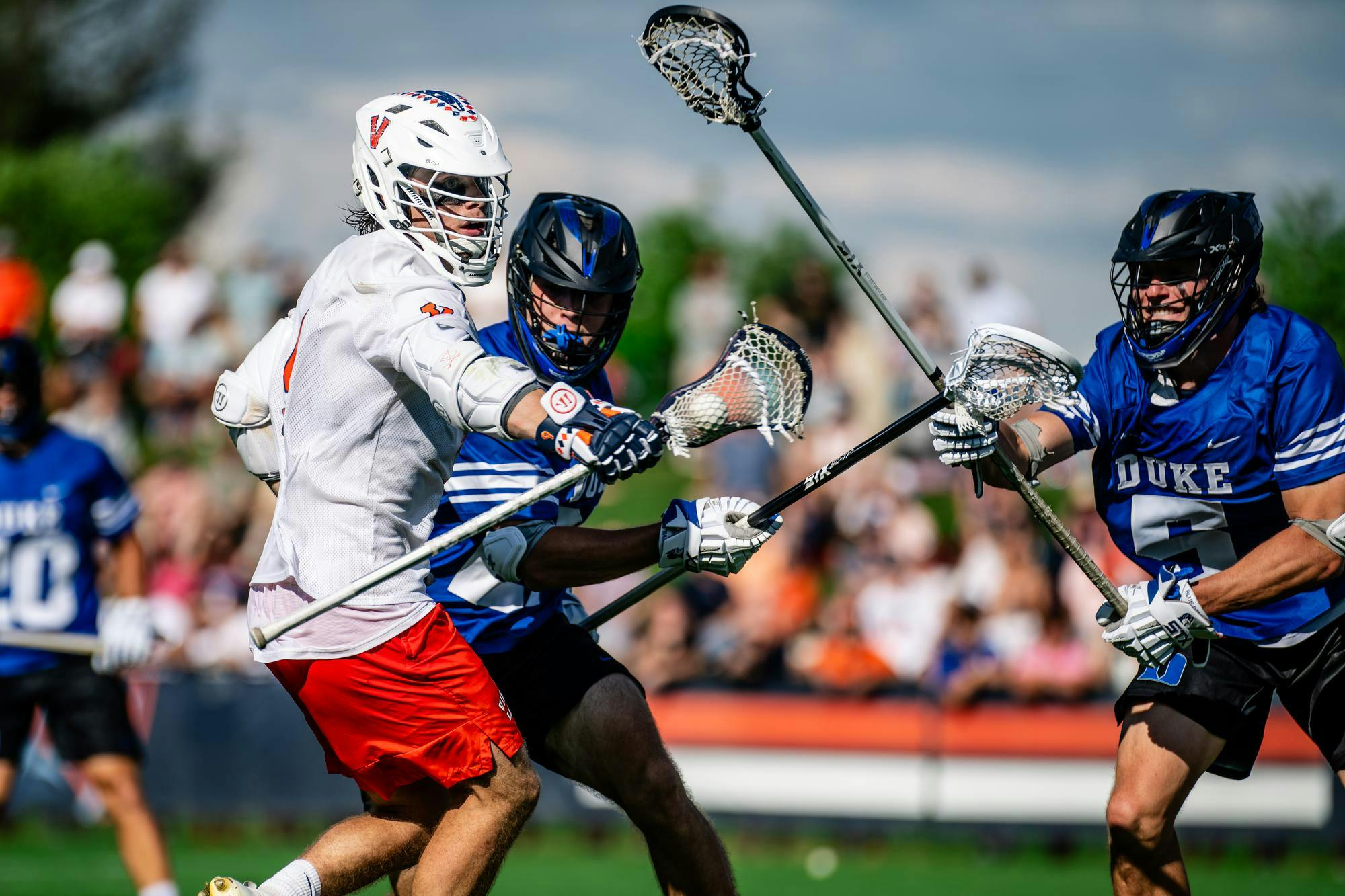 McCabe Millon wrestles with two Duke defenders.