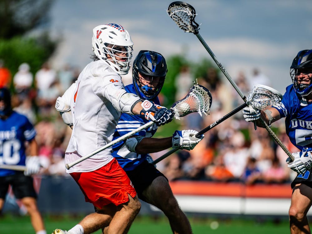 McCabe Millon wrestles with two Duke defenders.