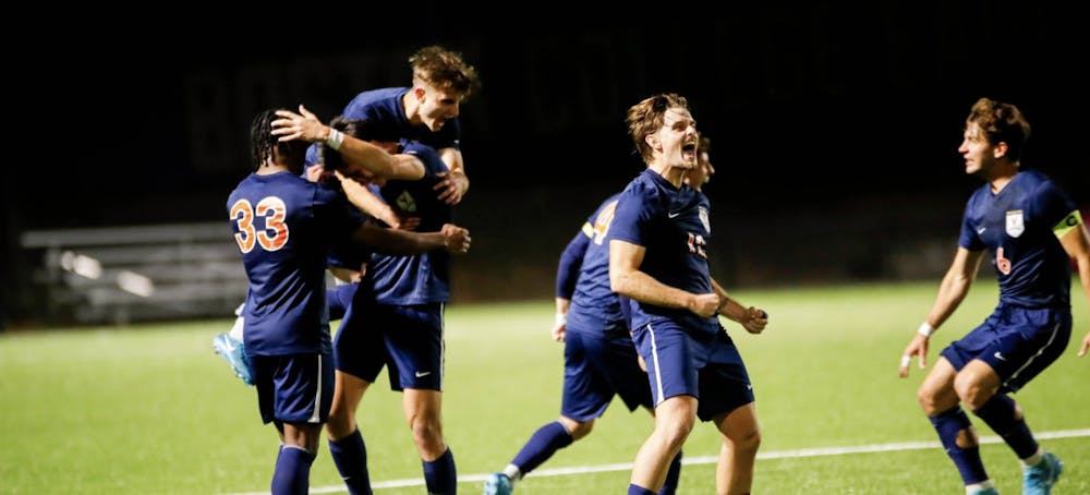 <p>The Cavaliers mob Nick Dang after his winning goal Friday evening.</p>