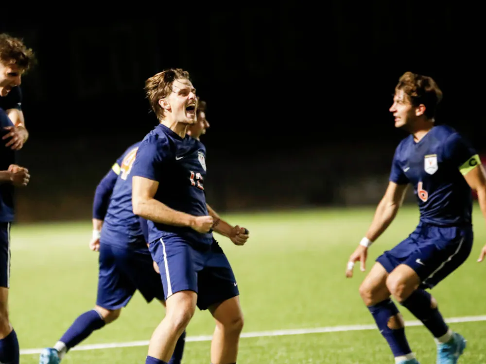 The Cavaliers mob Nick Dang after his winning goal Friday evening.