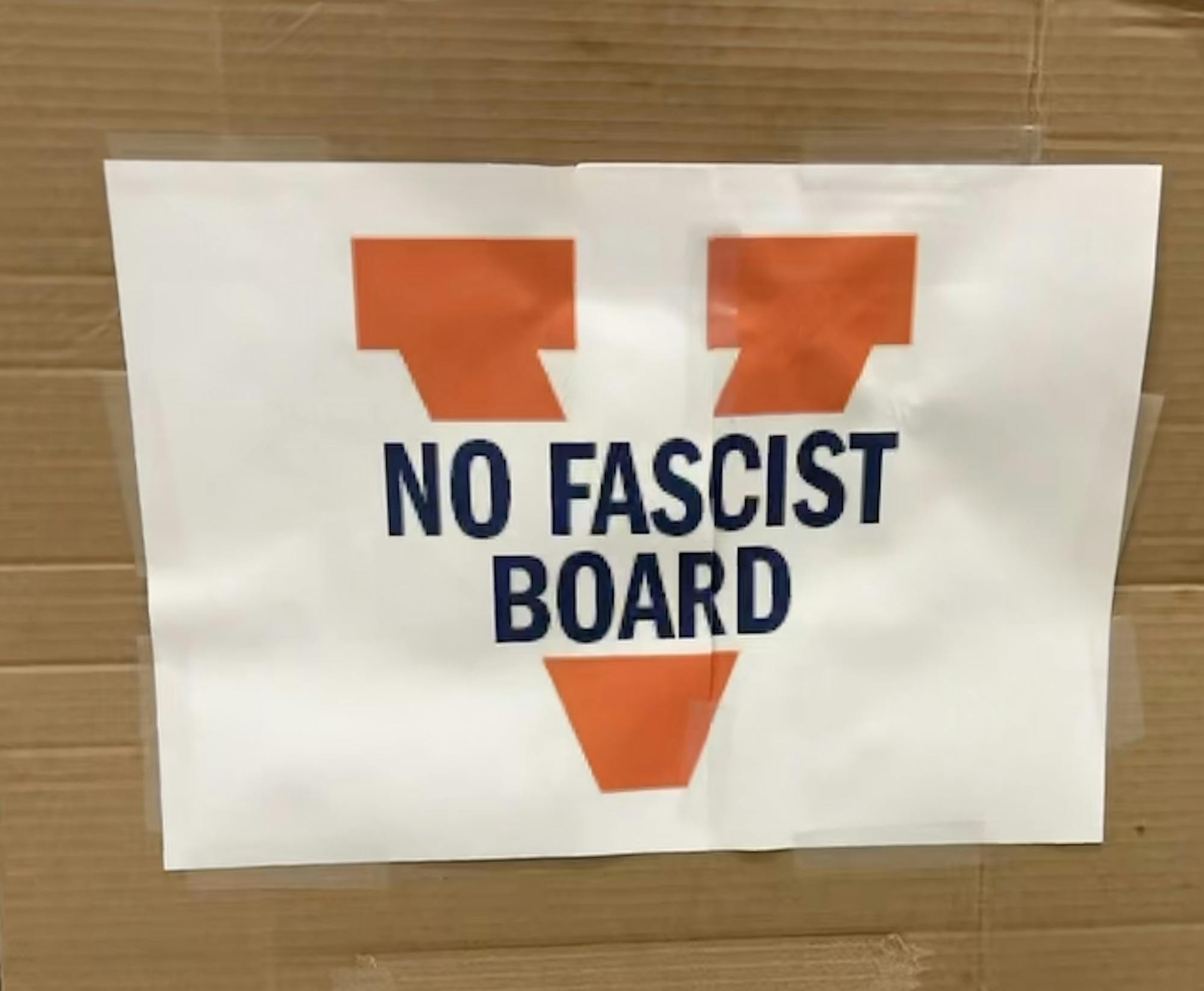 A sign brought by a faculty member to the meeting Friday. 